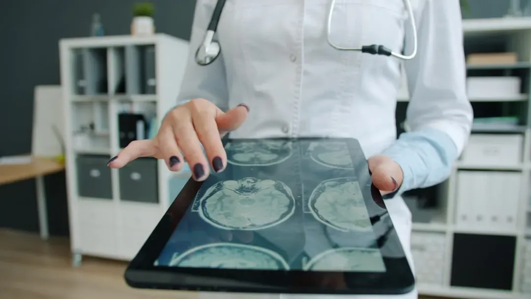 Endocrinologist reviewing hormone lab results on tablet in modern clinic, analyzing testosterone peptide data including Ipamo