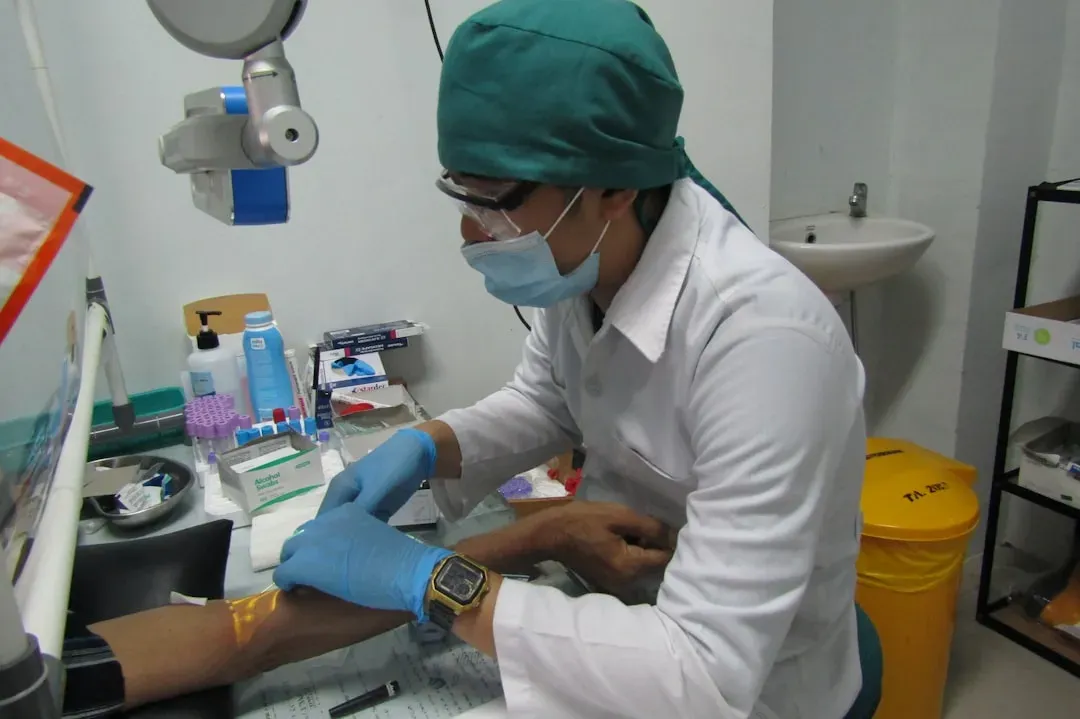 Healthcare provider administering peptide injection to patient during medical consultation for fat loss treatment like AOD-96